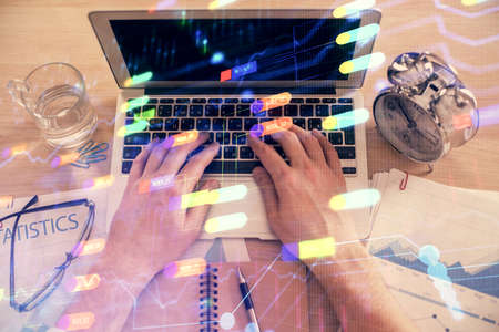 Double exposure of man's hands typing over computer keyboard and data theme hologram drawing. Top...
