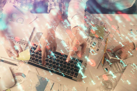 Double exposure of man and woman working together and data theme hologram drawing. Computer background. Top View.の写真素材