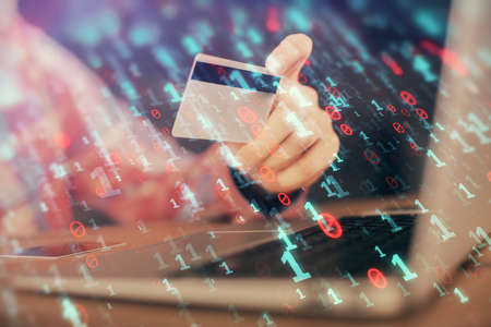 Double exposure of man hands holding a credit card and data theme drawing. E-commerce and technology...
