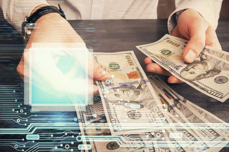 Double exposure of technology drawing hologram and us dollars bills and man hands. Data concept