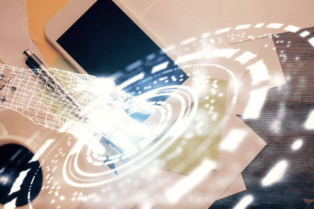 Double exposure of technology theme drawing over work table desktop. Top view. Global data analysis...