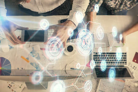 Double exposure of man and woman working together and data theme hologram drawing. Computer...