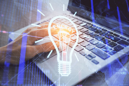 Double exposure of woman hands typing on computer and light bulb drawing. Idea concept.の写真素材