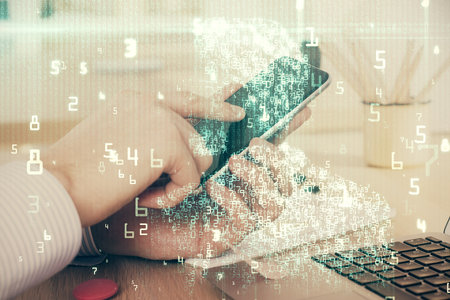 Double exposure of man's hand holding and using a digital device and data theme hologram drawing....