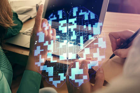 Double exposure of man and woman working together and technology theme drawing hologram.