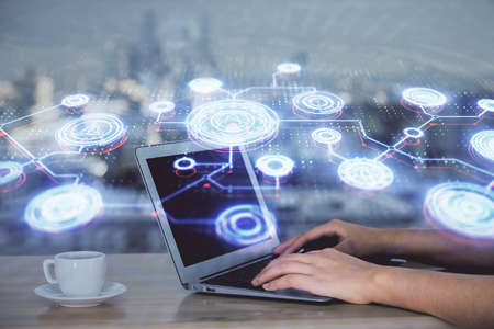 Double exposure of woman hands typing on computer and social network theme hologram drawing.