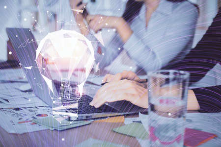 Double exposure of woman hands typing on computer and light bulb drawing. Idea concept.