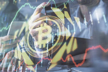 Double exposure of man and woman on-line shopping holding a credit card and crypto theme hologram...