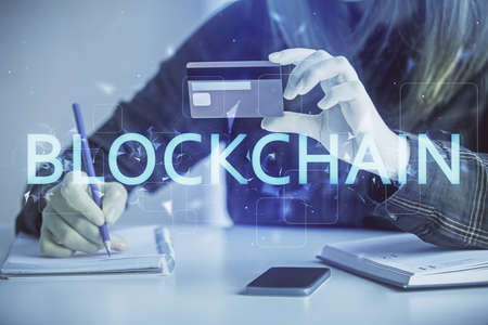 Multi exposure of woman on-line shopping holding a credit card and crypto theme drawing. Blockchain...