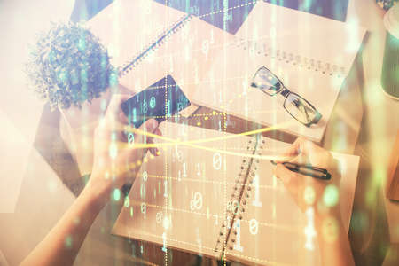 Double exposure of woman on-line shopping holding a credit card and data theme hologram drawing....