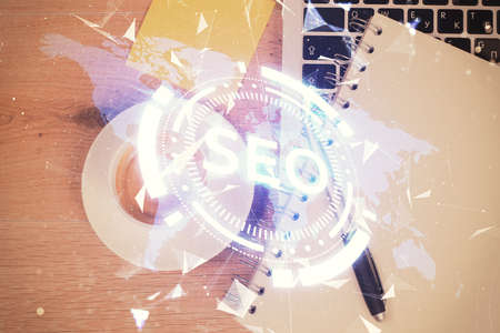 Double exposure of SEO drawing over study table background with computer. Concept of search. Top view.の写真素材