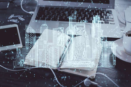 Double exposure of town drawings and desk with open notebook background. Concept of smart cityの写真素材