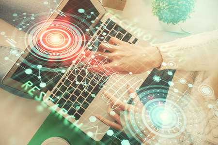 Double exposure of woman hands working on computer and data theme hologram drawing. Top View. Technology concept.の写真素材