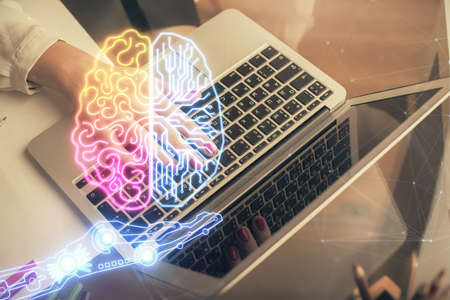 Multi exposure of woman hands working on computer and human brain hologram drawing. Ai tech concept.の写真素材