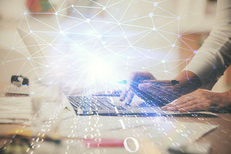 Double exposure of woman hands working on computer and data theme hologram drawing. Tech concept.の写真素材