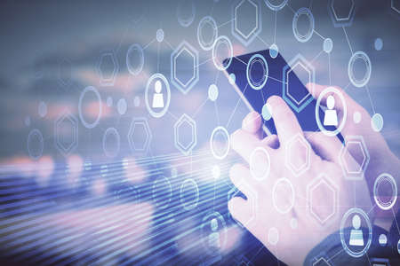 Double exposure of man's hands holding and using a phone and social network theme drawing.