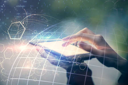 Double exposure of map sketch hologram and woman holding and using a mobile device.