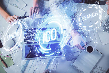 Double exposure of man and woman working together and crypto finance theme hologram. Blockchain...
