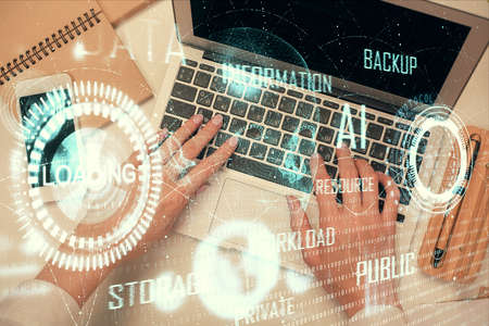 Double exposure of woman hands working on computer and data theme hologram drawing. Top View. Technology concept.の写真素材