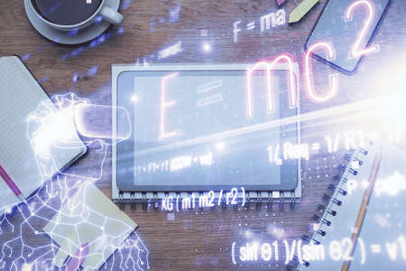 Double exposure of formula drawing over table with phone. Top view. Education concept.