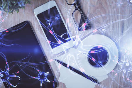 Double exposure of neuron drawing over table with phone. Top view. Science education concept.