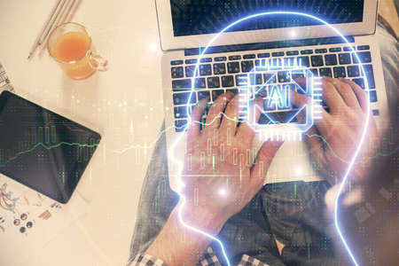 Double exposure of man's hands typing over computer keyboard and brain hologram drawing. Top view....