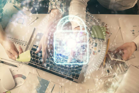 Double exposure of man and woman working together and lock hologram drawing. Security concept....