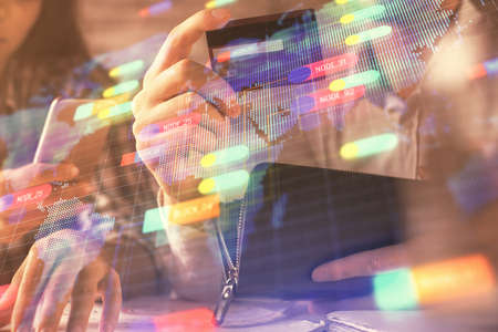 Double exposure of man and woman on-line shopping holding a credit card and data theme hologram...