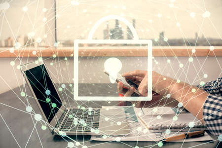 Multi exposure of man's hands holding and using a digital device and lock drawing. Security concept.