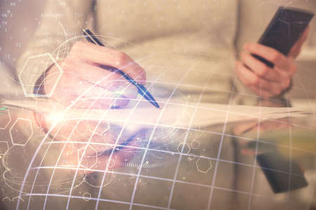 Double exposure of map sketch hologram and woman holding and using a mobile device.