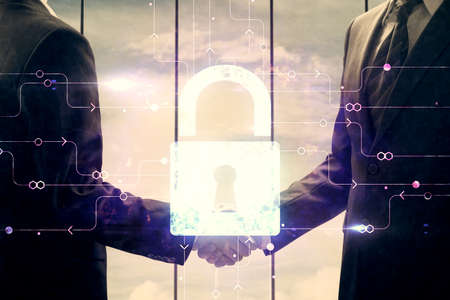 Double exposure of lock hologram and handshake of two men. Partnership security concept.