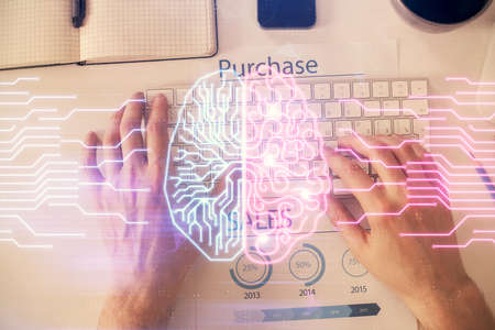 Double exposure of man's hands typing over computer keyboard and brain hologram drawing. Top view....