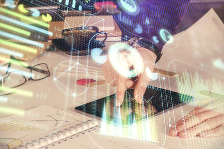 Double exposure of man's hand holding and using a digital device and data theme drawing. Technology...