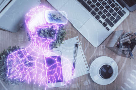 Double exposure of drawing man in AR glasses over table with phone. Top view. VR concept.