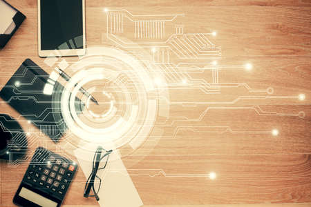 Double exposure of technology theme drawing over work table desktop. Top view. Global data analysis...