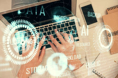 Double exposure of woman hands working on computer and data theme hologram drawing. Top View. Technology concept.の写真素材