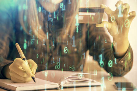 Double exposure of woman on-line shopping holding a credit card and data theme hologram drawing....