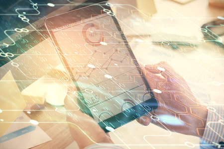 Multi exposure of man's hands holding and using a digital device and data theme drawing. Innovation...