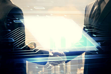 Double exposure of data theme hologram and handshake of two men. Partnership in IT industry concept.