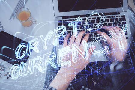 Double exposure of man's hands typing over computer keyboard and crypto currency theme hologram drawing. Top view. Blockchain concept.の写真素材