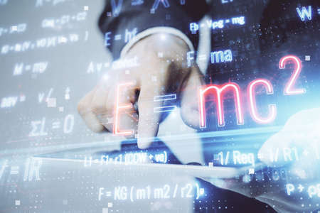Double exposure of man's hands holding and using a phone and formulas drawing. Education concept.