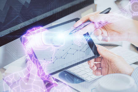 Double exposure of man's hands holding and using a digital device and AR glasses drawing. Virtual reality concept.の写真素材