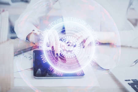 Double exposure of tech icon hologram and woman holding and using a mobile device. Technology concept.の写真素材