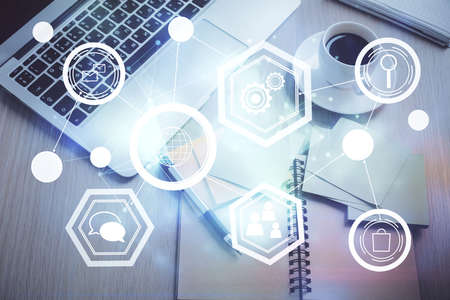 Social network hologram drawings over computer on the desktop background. Top view. Double exposure.の写真素材