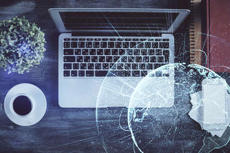 Social network hologram drawings over computer on the desktop background. Top view. Double exposure.