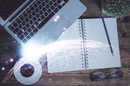 Social network hologram drawings over computer on the desktop background. Top view. Double exposure.の写真素材