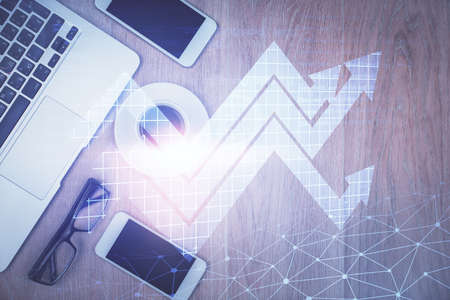 Double exposure of drawing arrows over table with phone. Top view. Growth concept.の写真素材