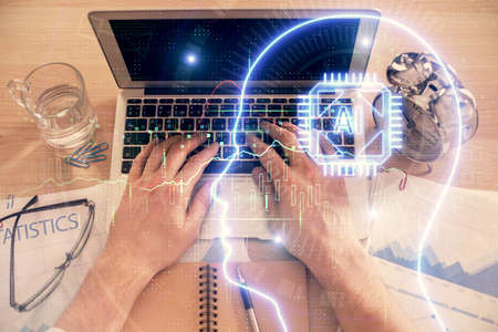 Double exposure of man's hands typing over computer keyboard and brain hologram drawing. Top view....