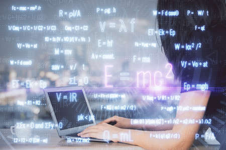 Double exposure of woman hands typing on computer and formula hologram drawing. Education concept.の写真素材