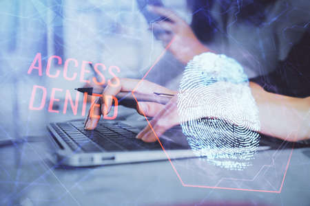 Double exposure of woman hands typing on computer and fingerprint drawing. Security concept.の写真素材
